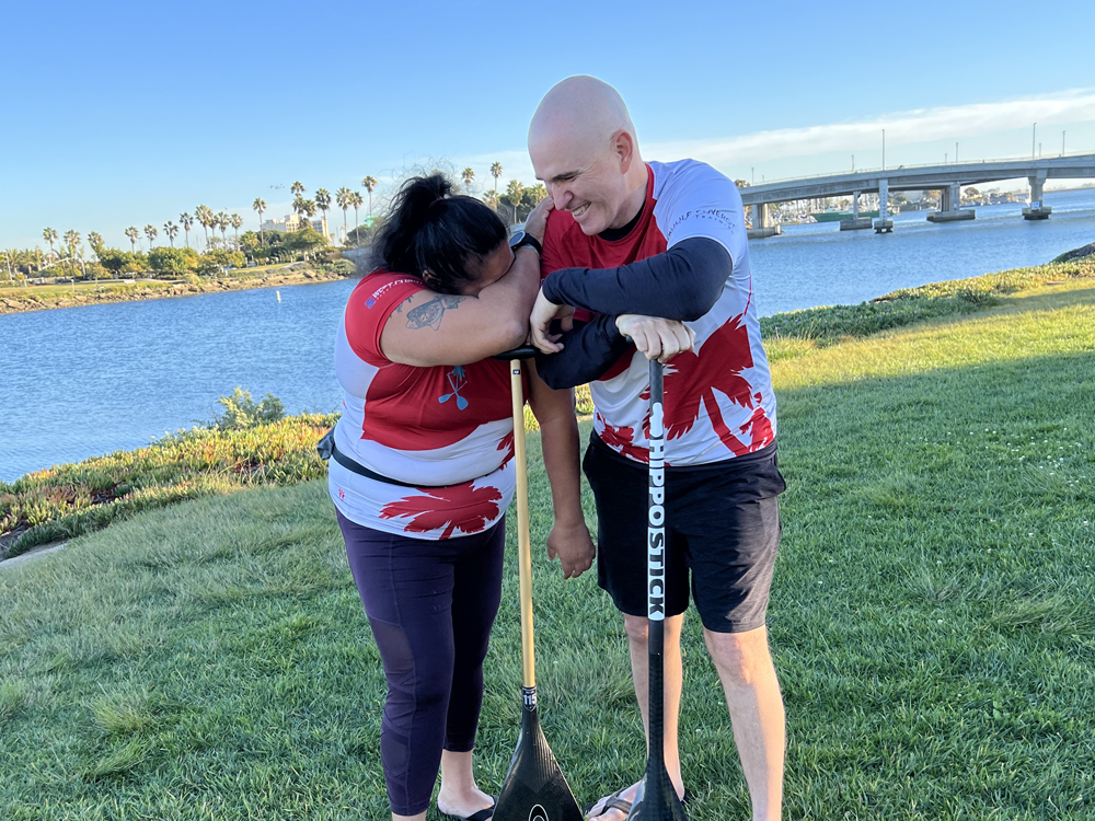 Nea and Harlen on the shore, laughing